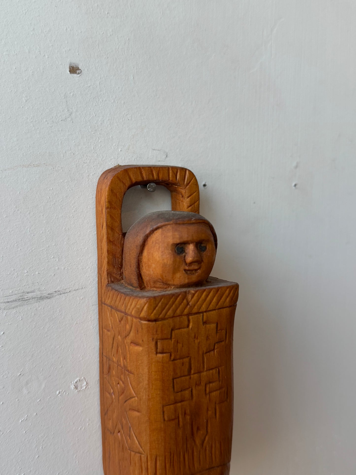 Folk carving of baby in its carrier