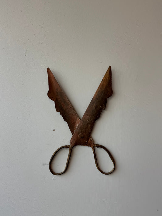 Barbers signage in the shape of two faces